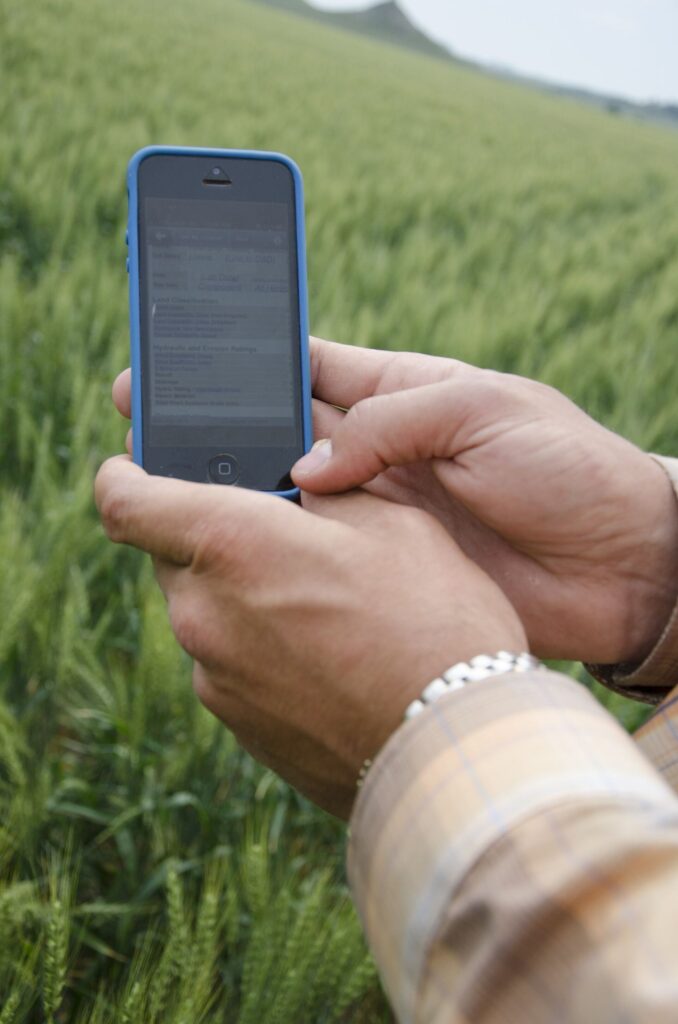 A person holding a modern smartphone with a bright display
